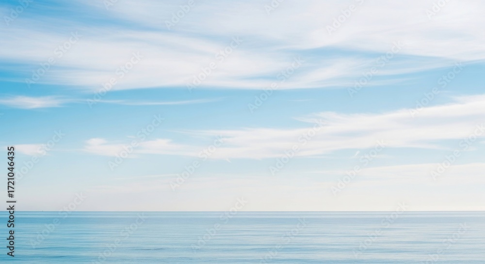 Obraz premium Serene ocean vista with tranquil waters beneath a bright, cloudy sky