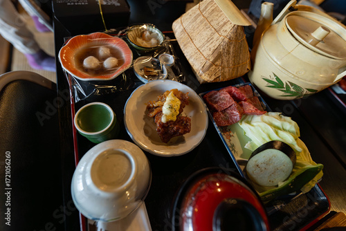 Miyazaki beef with nanban chicken and seasoned rice in a traditional house casing made out of dried leaves 