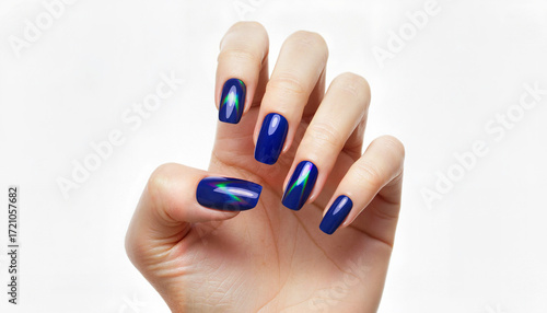 Woman's hand displaying shiny blue nail polish with rainbow reflection  