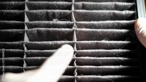 Mechanic Inspecting a Dirty Car Cabin Air Filter. Close-up of Dust and Debris on the Filter. HVAC System Maintenance and Air Quality Concept.