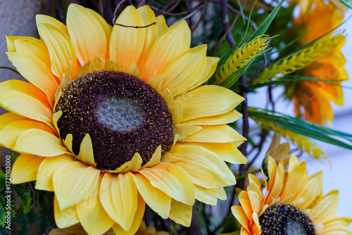 Bright yellow sunflowers add cheer to a spring decoration in a cozy garden setting