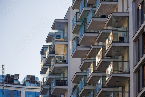 Glass balconies in multi-family buildings, apartment density, real estate, and housing market.