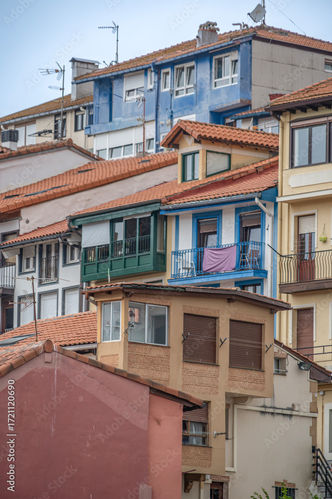 Fototapeta premium Layered Colorful Houses In Traditional Basque Coastal Village Spain. Multi Level Architecture, Painted Facades, Cantabrian Coast, Residential Buildings