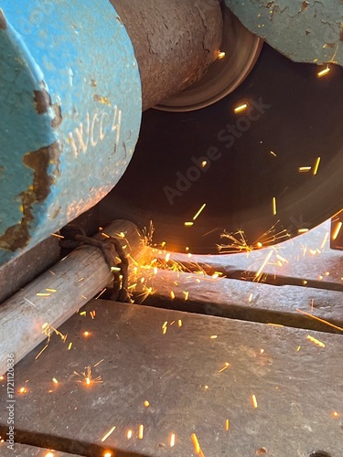 Close-up of metal cutting with industrial circular saw, creating sparks – a powerful depiction of fabrication, construction work, and industrial safety operations.