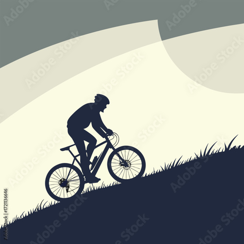 Silhouette of a cyclist riding a mountain bike on a grassy hill