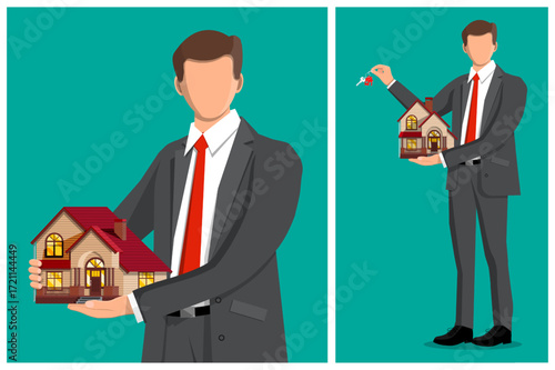 Man realtor showing small house model and holding keys. Real estate agent or broker for property sale. Home rent concept.
