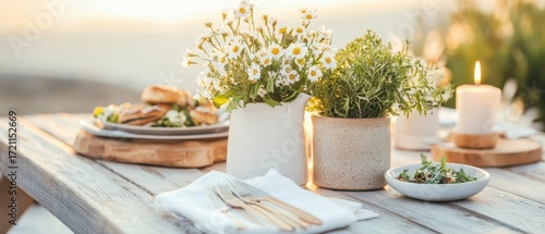 Wallpaper Mural Outdoor dining table setting with fresh flowers and a lit candle during golden hour warm light Torontodigital.ca