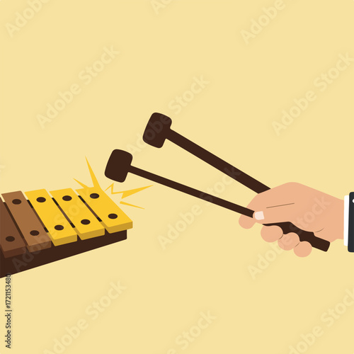Hand strikes xylophone keys with mallets producing music on a light yellow background