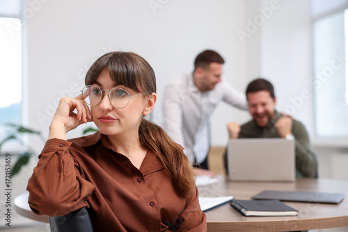 Obraz na plátně Woman feeling jealous of her colleague's success in office, selective focus