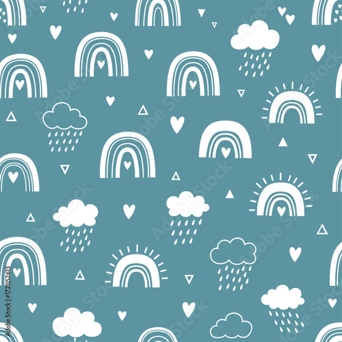 A whimsical pattern featuring simple rainbows and clouds with hearts and triangles in a teal background.