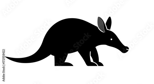 Silhouette of a black aardvark with long snout and upright ears on a white canvas