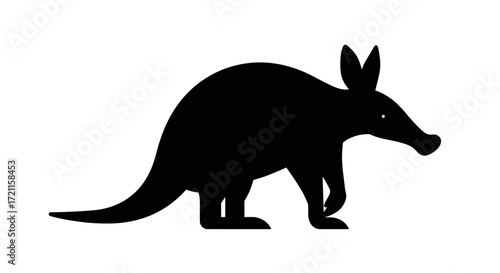 Silhouette of a black aardvark walking with its distinct long snout and ears visible
