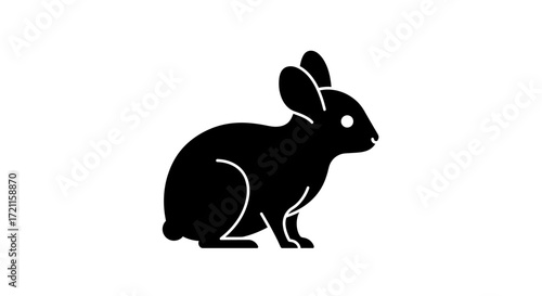 Simple silhouette of a black rabbit sitting upright with ears perked lively and cute barnyard animal