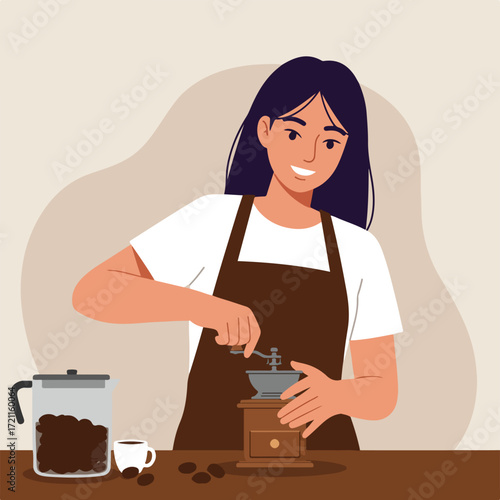Woman grinds coffee beans with hand-cranked grinder, cup and beans nearby
