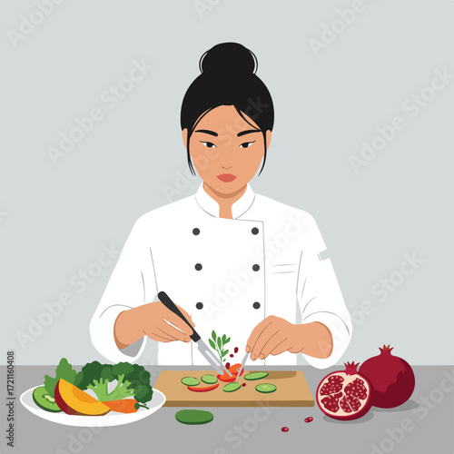 Chef in white coat cuts vegetables on cutting board beside pomegranates