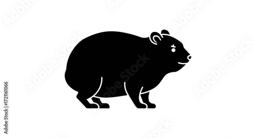 Chunky black silhouette of a wombat standing alertly on a