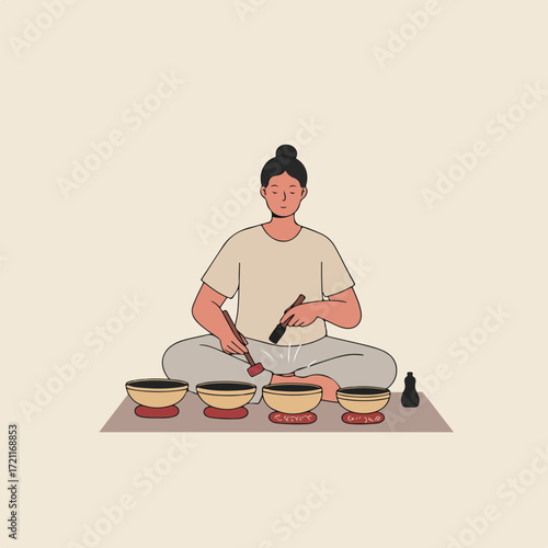 Meditating woman plays singing bowls