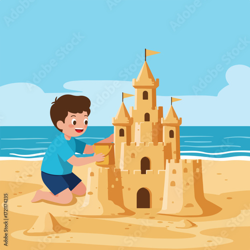 Boy building a sandcastle on the beach with a bucket near the ocean