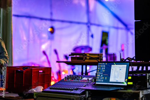 Obraz na plátně An audio engineer or sound technician operates a mixing board and laptop, managi
