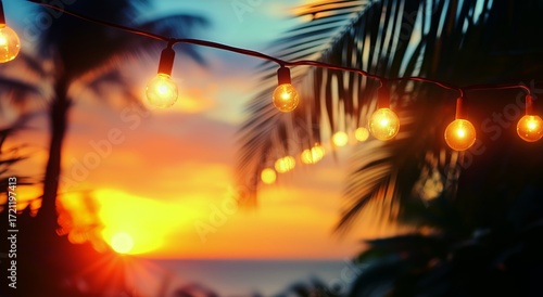 Colorful Sunset With String Lights Illuminating a Tropical Setting Near the O...