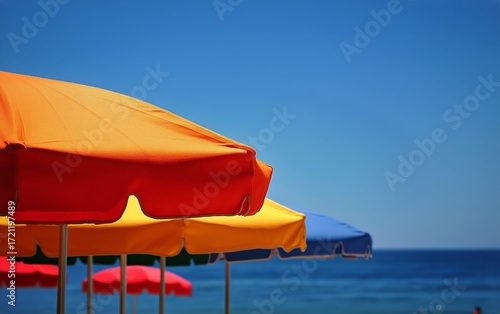 Bright Umbrellas Line the Beach Along the Calm Sea Under a Clear Blue Sky on ...