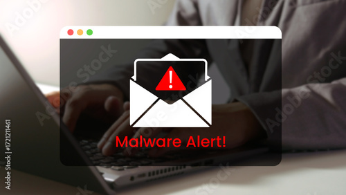 Fotografie Cyber Threat Notification: A computer user faces a stark warning with a Malware Alert popup notification on their laptop screen, highlighting the dangers of online security and digital threats
