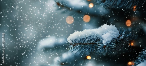 Snow Gently Falls on Frosted Pine Branches Lit Warmly on a Serene Winter Even...