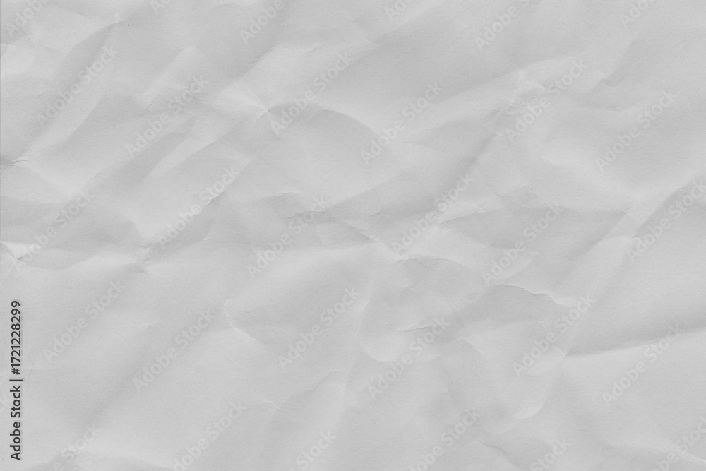 Obraz premium Crumpled white paper texture with visible creases and folds, ideal for backgrounds or design elements. paper appears slightly wrinkled, adding tactile and realistic effect