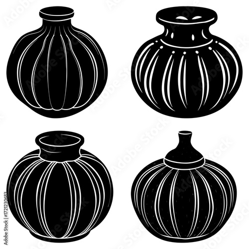 Collection of four black and white vases with different shapes and decorative line patterns displayed together