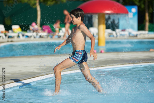 Wallpaper Mural Young boy enjoying fun at a water park Torontodigital.ca