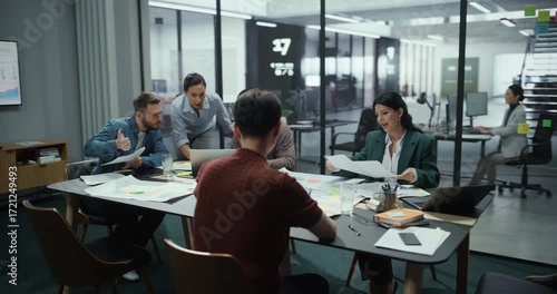 Diverse Group of Professional Businesspeople Meeting in the Modern Office Conference Room. Creative Team Sitting Behind a Table, Discussing Corporate Strategy, Financial Reports, Business Plans