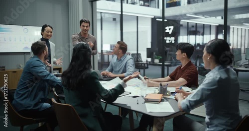 Marketing Department Managers Presenting a New Successful Strategy on a Large Screen. Colleagues Watch with Interest, Agree on Commercial Points, Celebrate with a Group High Five