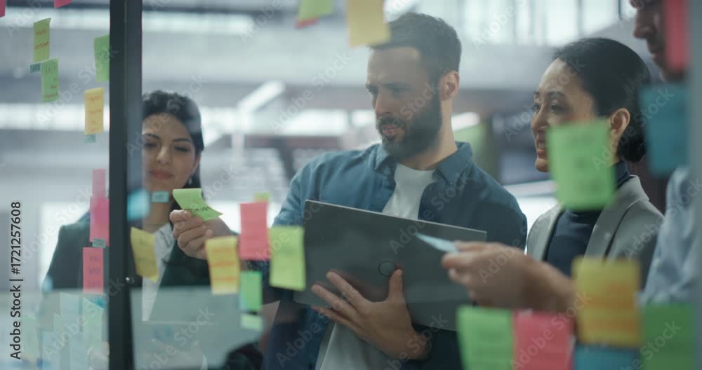 Employees Use Sticky Notes on a Glass Wall to Map Out Product Features ...