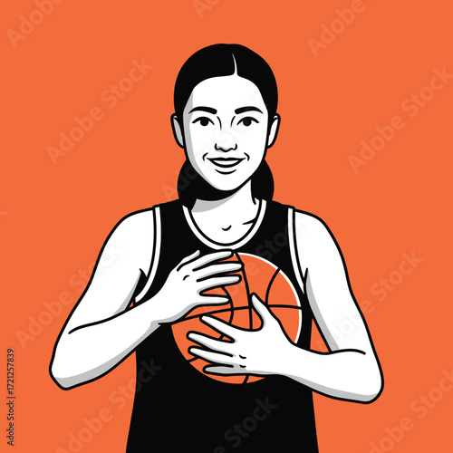 A smiling woman basketball player holding a ball.