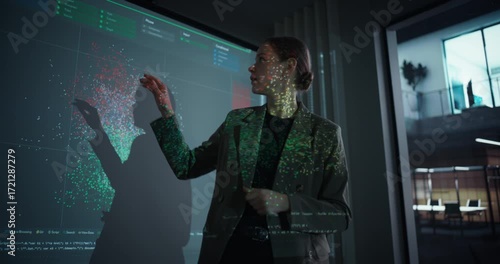 Female IT Professional Delivering a Keynote Presentation on Artificial Intelligence in a Modern Conference Room. She Stands in Front of a Screen with Machine Learning Charts and Digital Data Visuals