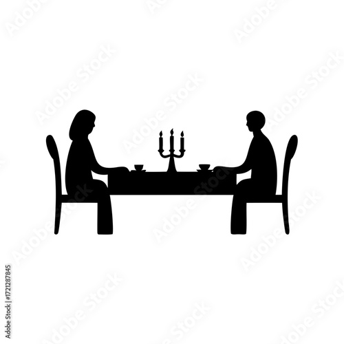 Silhouette of couple having romantic dinner with candlelight on table and chairs