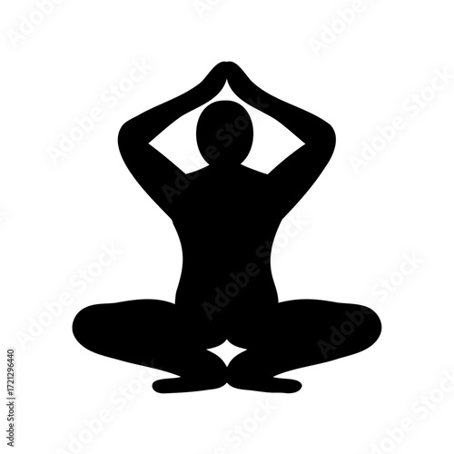 Silhouette of person meditating in lotus position with hands above head