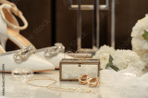 Wedding accessories rings, shoes and perfume on a table