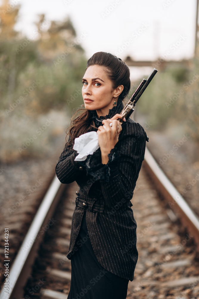 Fototapeta premium Woman Aiming Revolver in Vintage Attire Outdoors