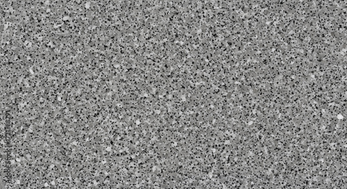 A detailed close-up of a rough, grainy gray asphalt or concrete surface texture.