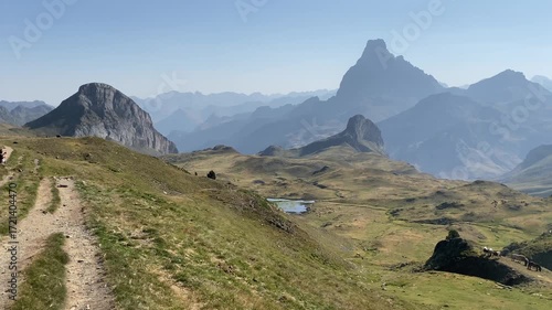 Hikers enjoy the landscape in the Pyrenees mountain range during a break in the walk