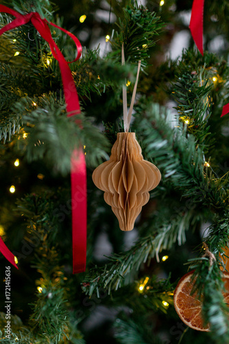 Christmas decorations: paper lantern on a branch of the christmas tree.