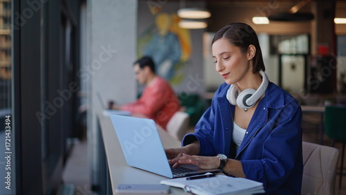 Inspired writer typing computer thinking on creative ideas at cafeteria closeup.