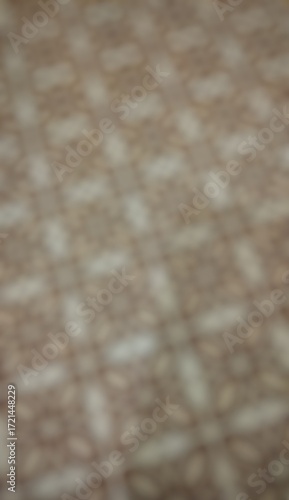 This is a blurry, abstract, and out-of-focus image of a patterned surface.