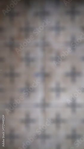 This is a blurry, abstract, and out-of-focus image of a patterned surface.