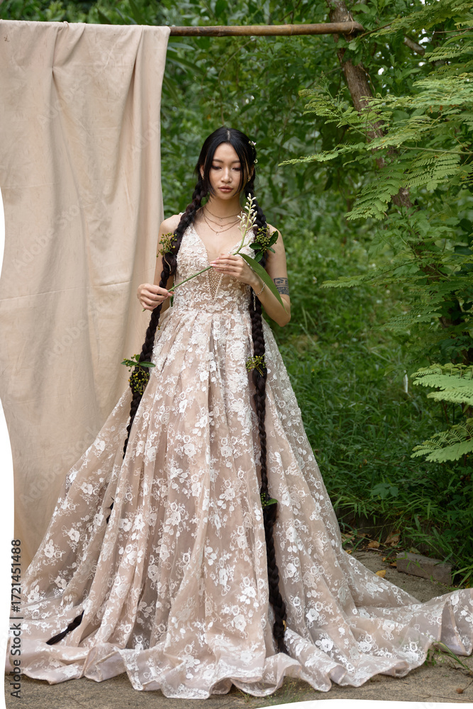 Fototapeta premium Young lady with long hair in floral gown outside.