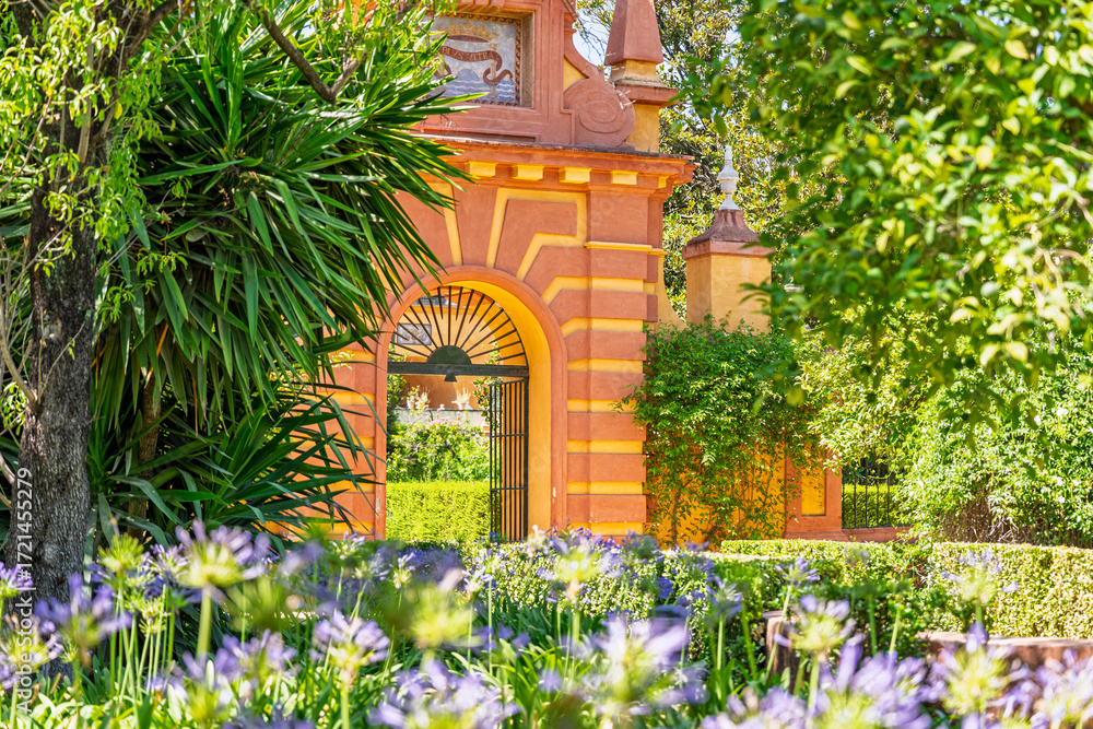 Fototapeta premium The gardens, flowers and architecture at the Real alcazar de Sevilla or the Royal Alcazar of Seville in Spain. 