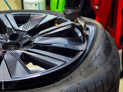 The car tire is being changed on a tire removal and installation machine.