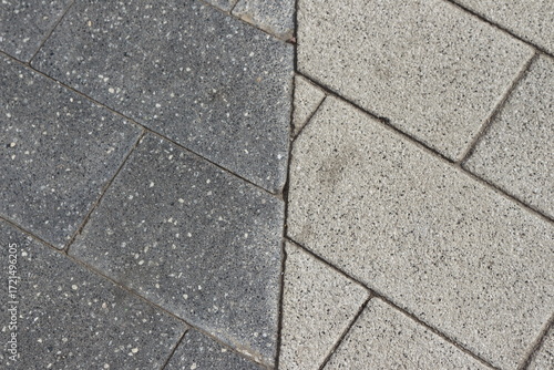 Black and gray paving slabs, borders on a city street.