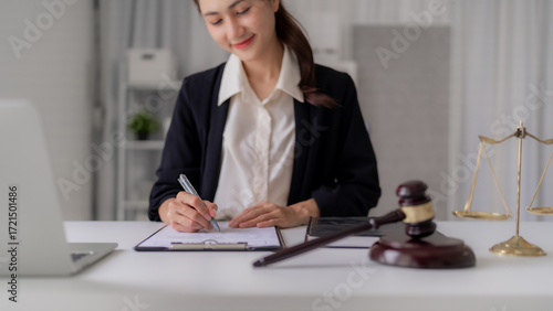 Asian Female Lawyer Signs Legal Document at Office with Gavel and Scales of Justice Court Legal Advice Justice Lawyer Legal System Law Firm